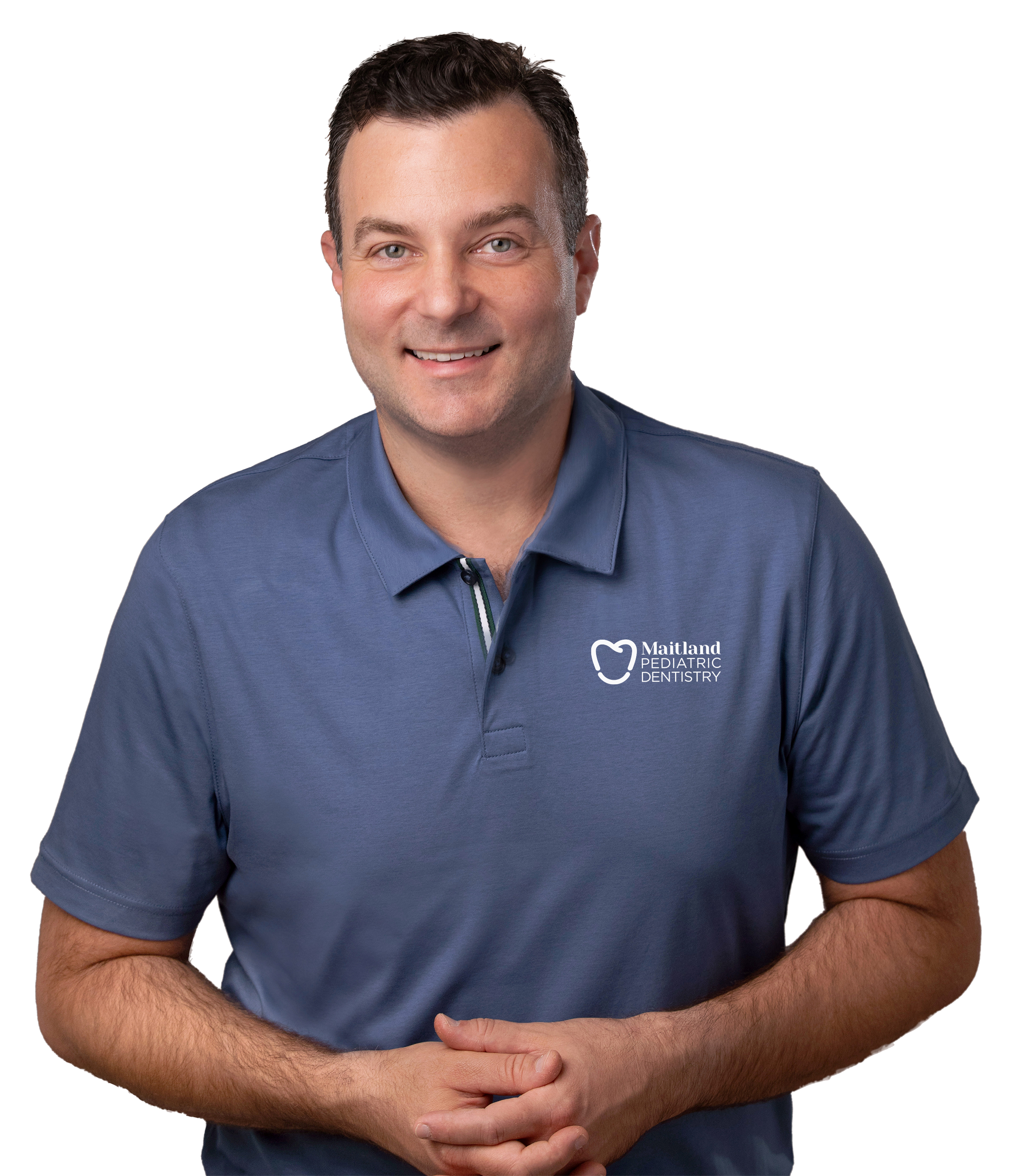 A man in a blue polo shirt with folded hands. Dr. Domenic Aloise, Board Certified Pediatric Dentist at Maitland Pediatric Dentistry.